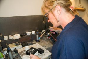 Sandra Kerns working in her studio with a blowtorch